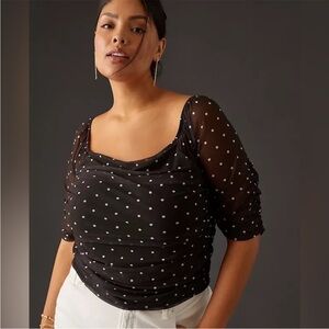 By Anthropologie Semi sheer polka dot black fitted top.  size L